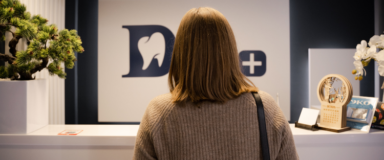 Back of female walking into doctors office reception